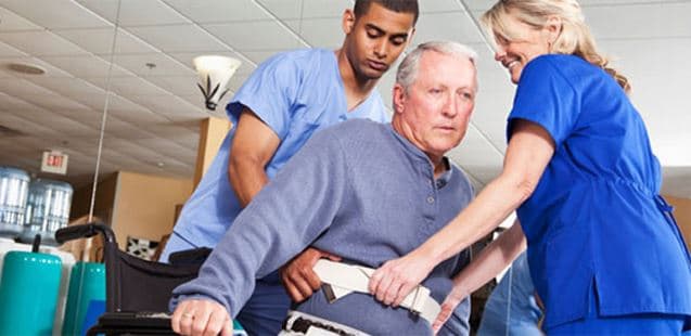 A Stockwellcare carer supporting a service user with a walking frame